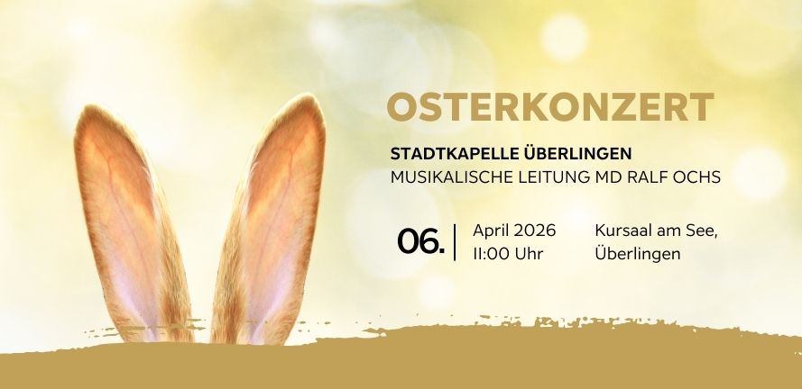 Banner für das Osterkonzert 2026 der Stadtkapelle Überlingen. Vor einem hellen, frühlingshaften Hintergrund mit Bokeh-Effekt ragen zwei Hasenohren aus einer goldenen Fläche am unteren Rand hervor. Rechts daneben stehen die Veranstaltungsdetails: 06. April 2026 um 11:00 Uhr im Kursaal am See, unter der musikalischen Leitung von MD Ralf Ochs.
